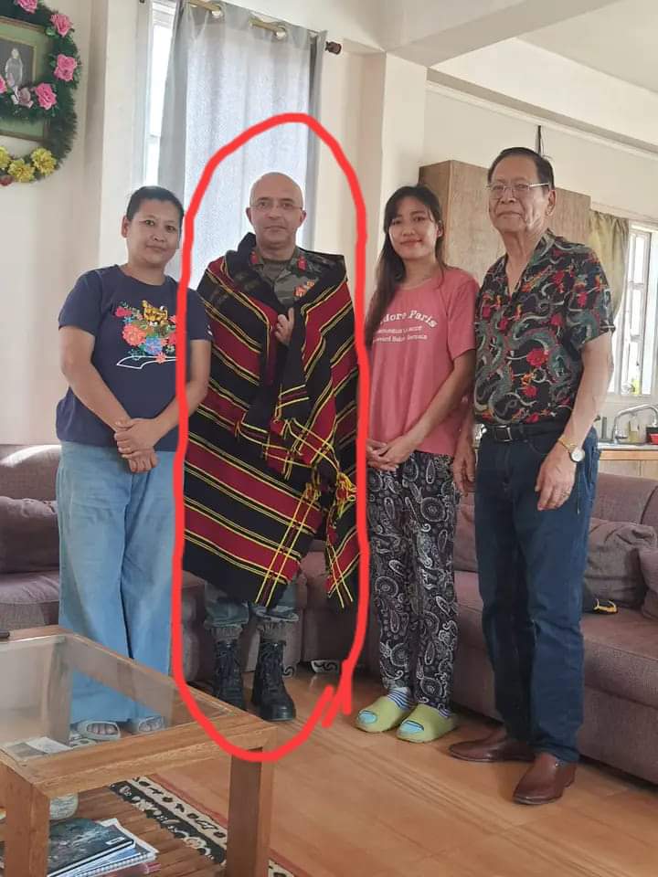 'Hum aapke seva mein haazir hain' in the form of an image.

<a href="/official_dgar/">The Assam Rifles</a> AR Man draped in kukichinzothu phanek. 

AR Man ready to accept seva. 

AR man ready to allow Kukichinzo terrorists to shoot at Meiteis from their bunkers. 

#ThisIsKuki_ZoStory
