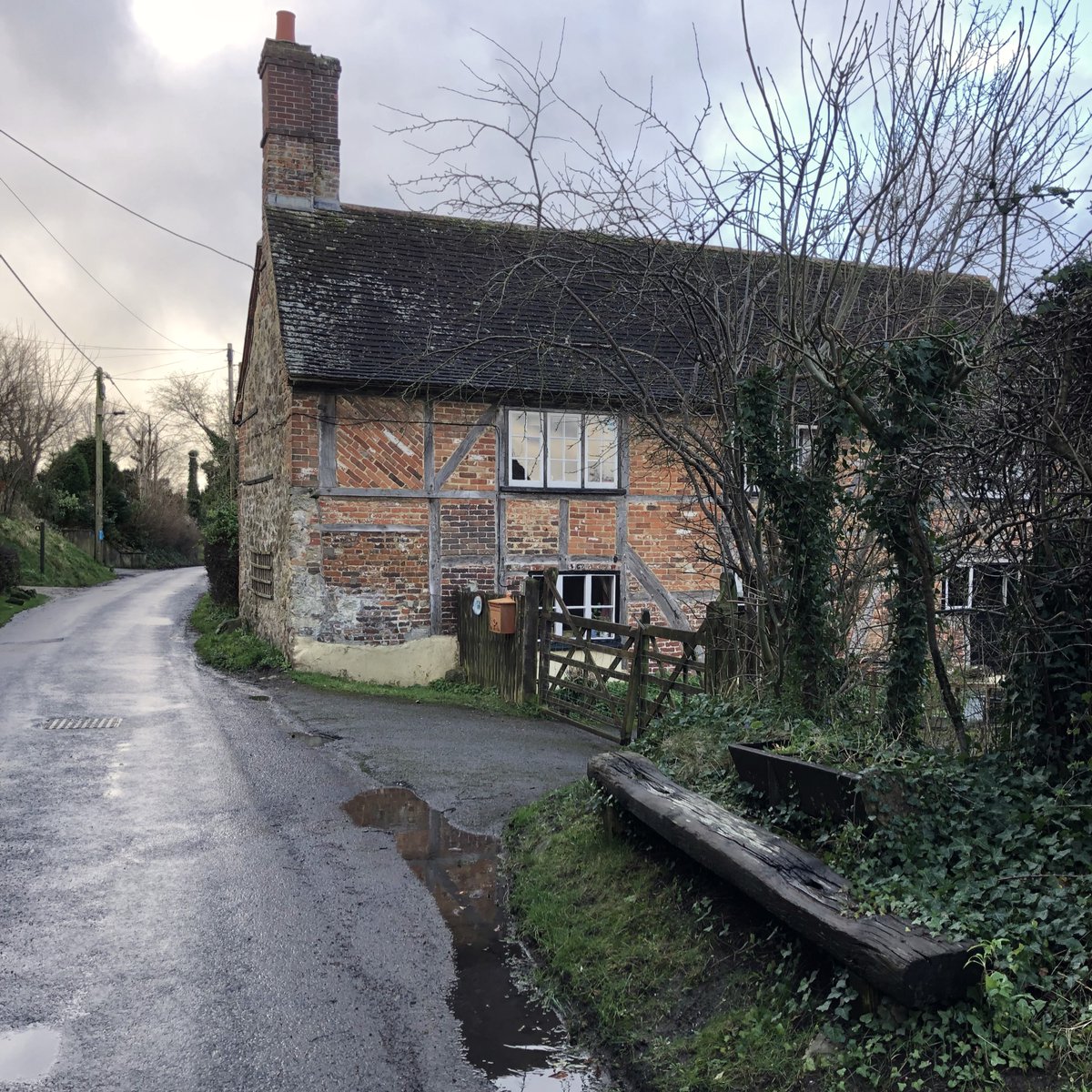 BitesizeBratton's tweet photo. They say that each morning small farms in Wiltshire put milk churns onto wooden roadside platforms ready for Arthur Pearce’s fleet of red TK Bedford trucks to come clattering along, slide them aboard and leave an empty churn for tomorrow. One platform still remains on Lower Road. https://t.co/3uZsToPIKv