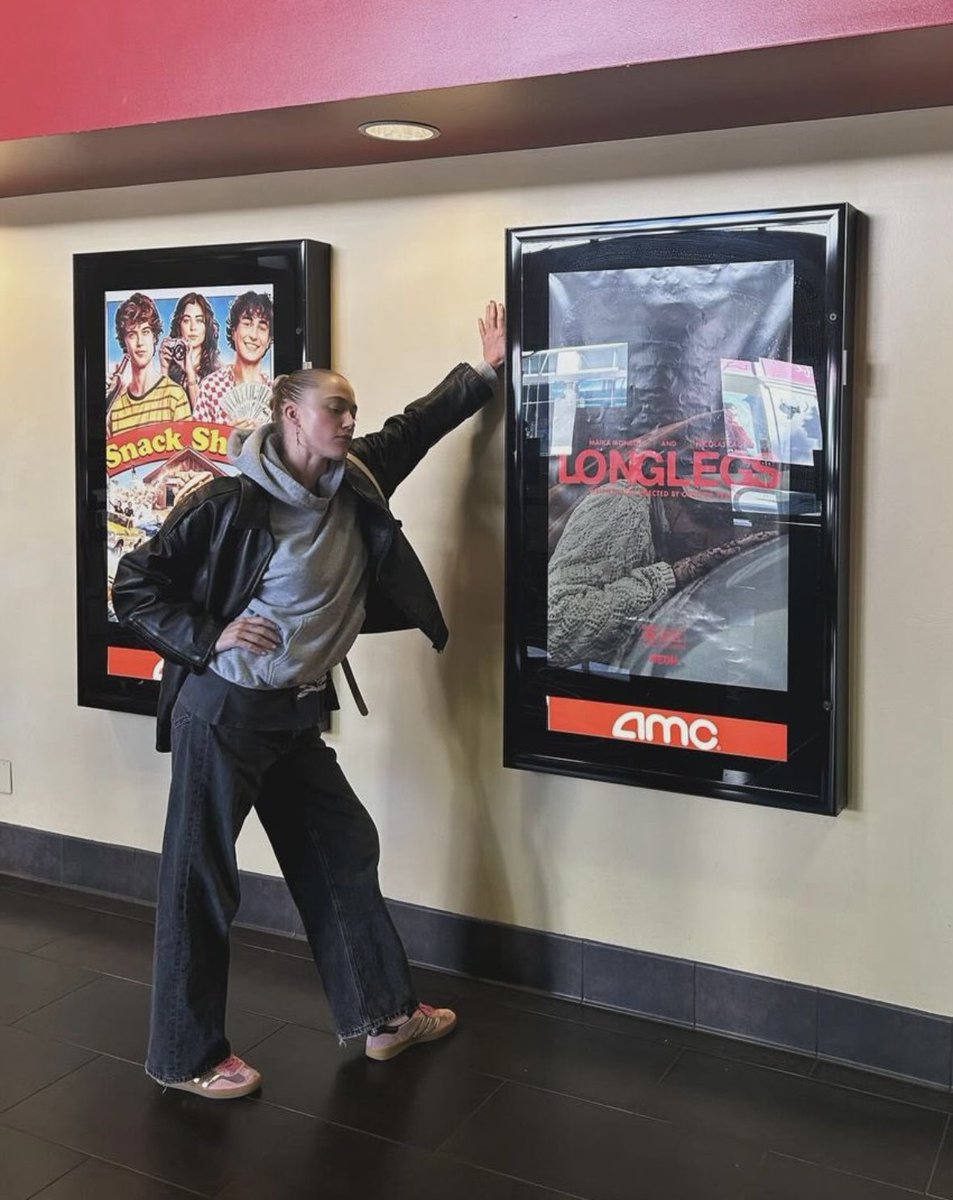 More Maika Monroe posing with Longlegs posters.
