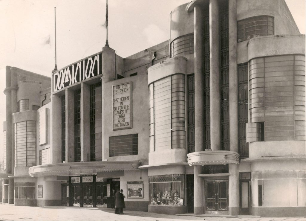 C20Society's tweet image. Great to see the restored façade of the former Dominion Cinema in Harrow being revealed in these new pictures.
Built in 1936 to designs by Frank Ernest Bromige, the Art Deco cinema was entombed in metal cladding from 1962 for nearly 60 years, until it was finally removed in 2021.…