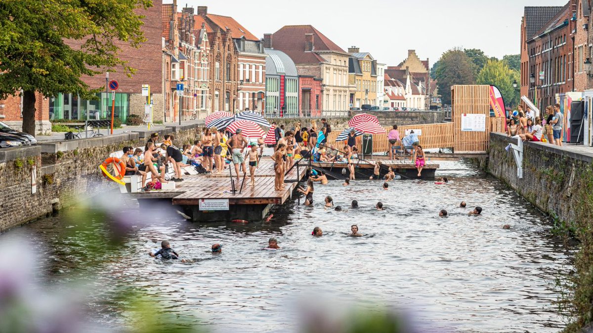 Around the world in 80 baths... Take a dip in the #swimming area in the canal at Coupure, Bruges. The city has closed off a stretch of canal &amp; constructed a wooden pontoon to create a 30m open-air #swimmingpool, open 1-8pm every day through the summer &amp; free!