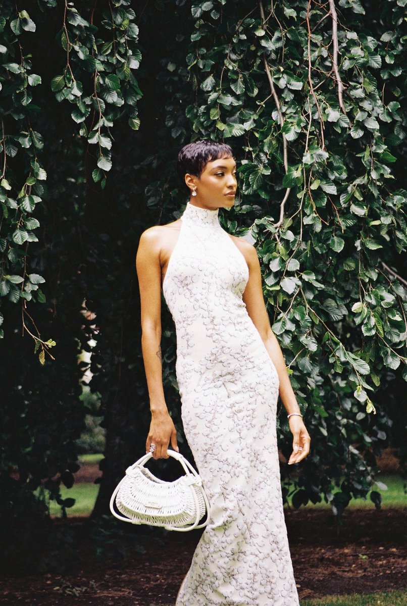 Balmain's tweet image. The radiant Jourdan Dunn graced the court at the 2024 Wimbledon Championships on Saturday. The model donned a dress from #BALMAINFW24, complemented by the exquisite and intricately woven Jolie Madame bag, evoking the picturesque charm of Bordeaux.