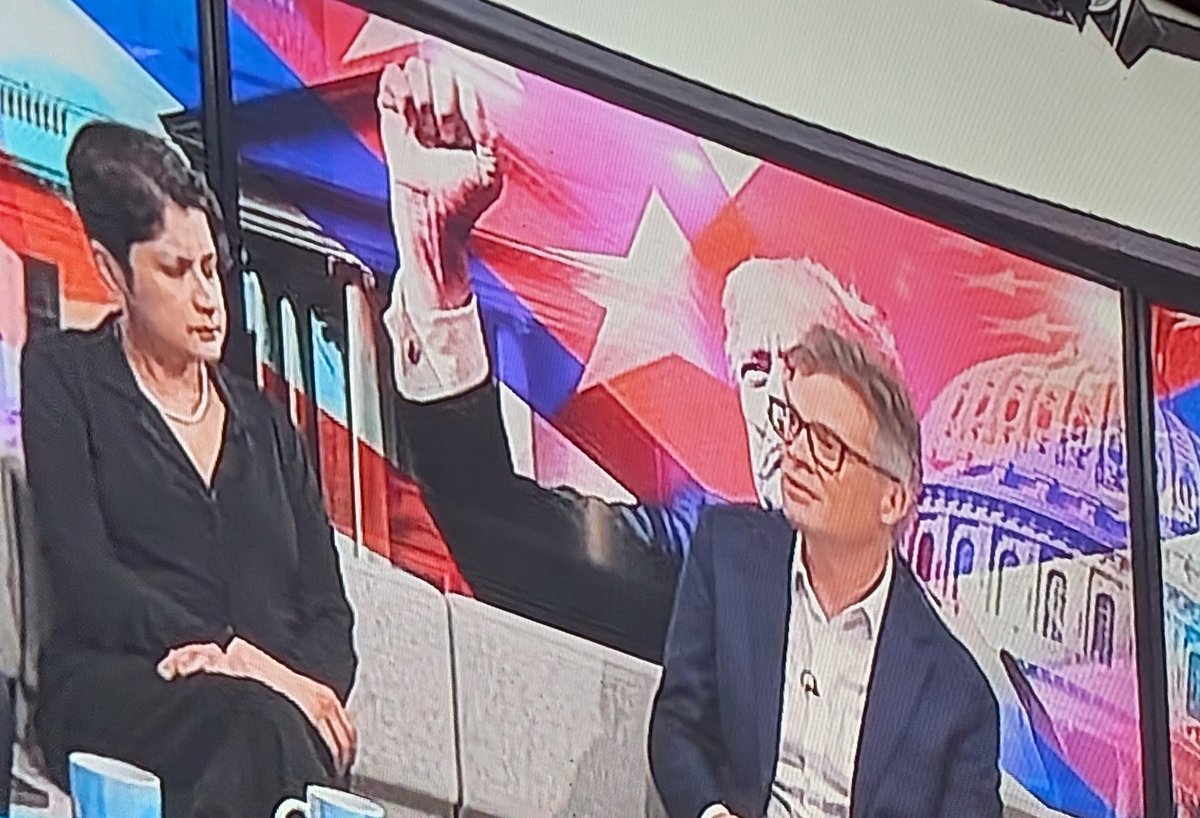 Shami looking quizzically at Nick Watt's giant arm on #BBCNewsnight