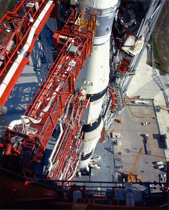 View looking down from the launch umbilical tower of the Apollo 11 Saturn V on Pad 39A at NASA’s Kennedy Space Center. In the foreground, numerous umbilical arms connect to the rocket.