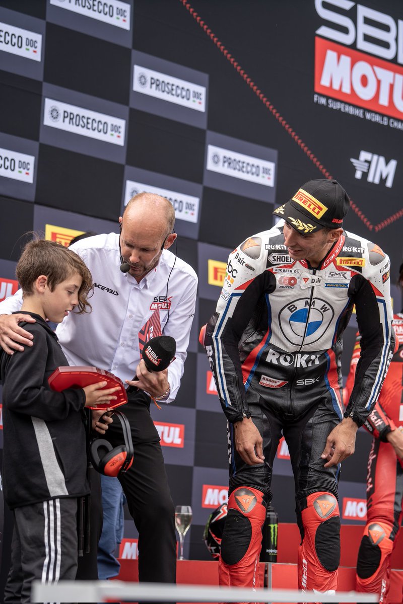Dazmoto748's tweet photo. This little lad lost his dad at Donington. @mhillofficial took him onto the stage while @toprak_tr54 was on the podium and handed him the fastest lap trophy. 10 seconds later his relieved dad turned up. 🙏If anyone knows the dad I'll pass these photos on https://t.co/w2cx034XSI