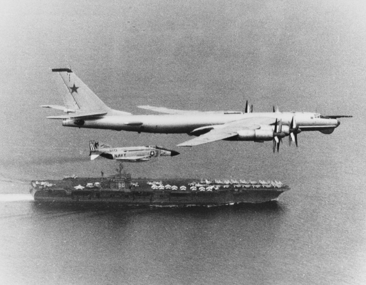 Boneyardsafari's tweet photo. #otd Tupolev TU-95 Bear is escorted by a VF-74 F-4J as it flies past USS Nimitz CVN-68, 15 July 1976. #cvn68 #ussnimitz #tu95 #vf74 #f4j #navalsafari #aviationsafari #aviationpreservation #boneyardsafari https://t.co/p9y6gO2B06