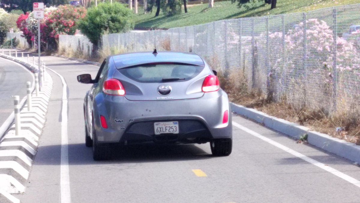 HoboBikeTouring's tweet photo. Car driving recklessly driving when cyclists are in a protected bike lane on Santa Fe Street between the brewery and campground in San Diego California https://t.co/JLF3DTp9ip