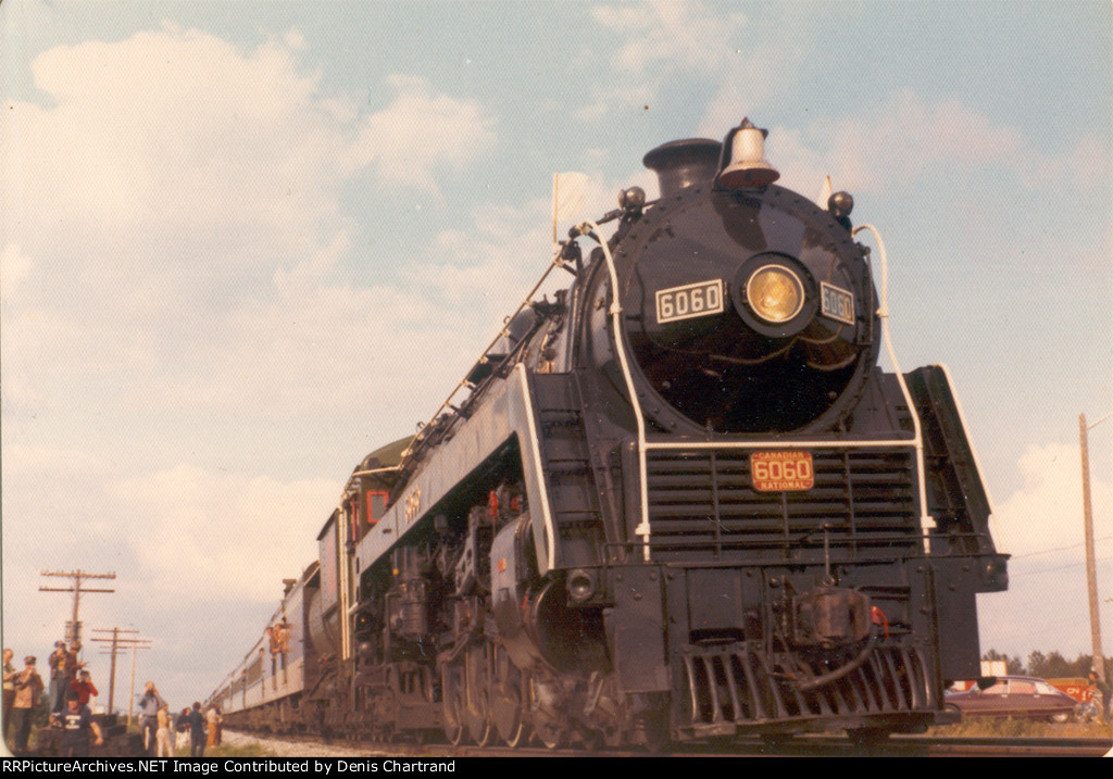 Jul 15, 1974: the engineer of CN 4-8-2 Mountain No. 6060 finds a hot bearing while inspecting the steam locomotive in Belleville, ON. The "Bullet Nose Betty" was returning to Toronto after pulling several excursion trains in the Montreal area. 1/2