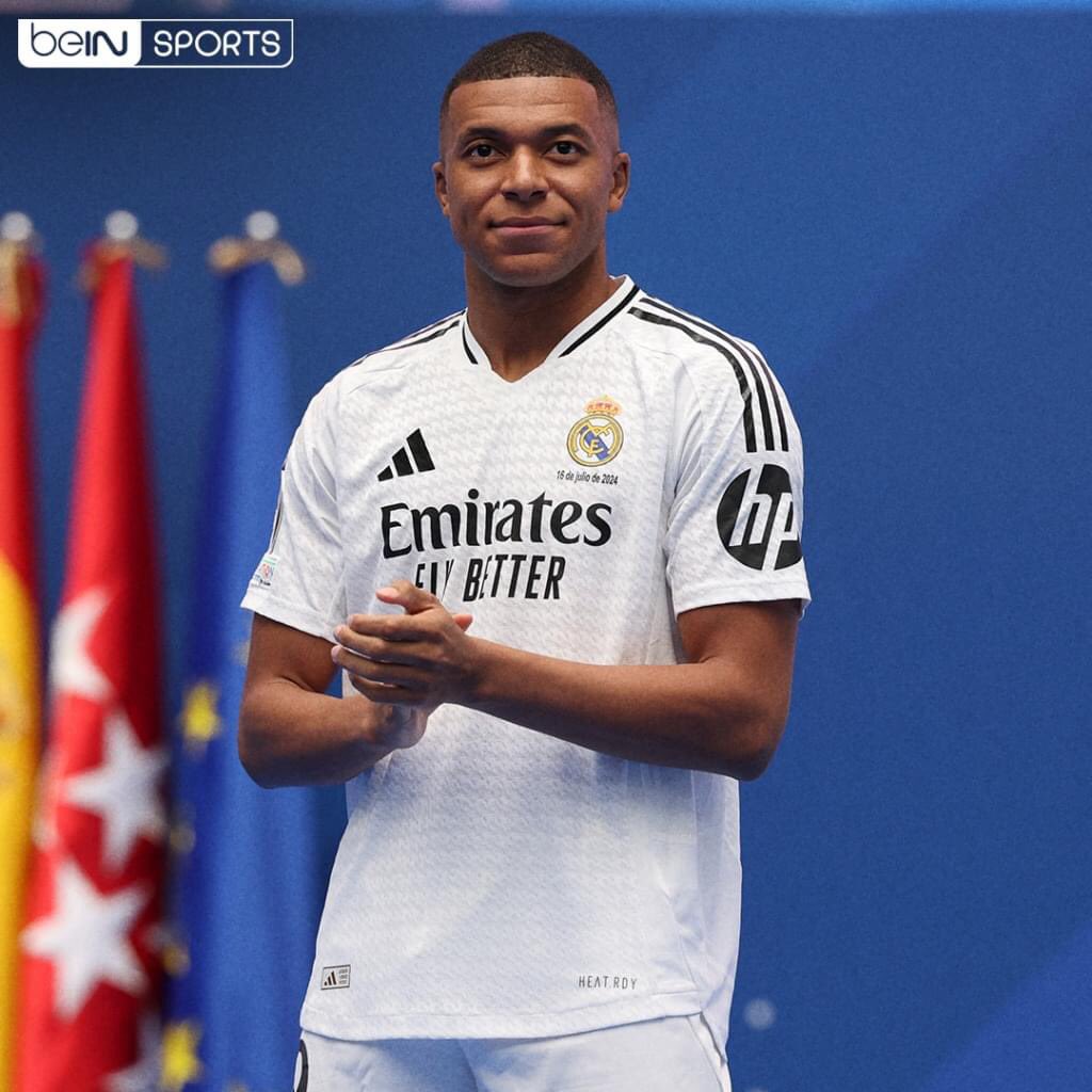trending_in_KE's tweet photo. Kylian Mbappe poses with Real Madrid's iconic No.9 shirt for first time alongside Florentino Perez after officially completing long-awaited transfer https://t.co/y2C6EwlJJW