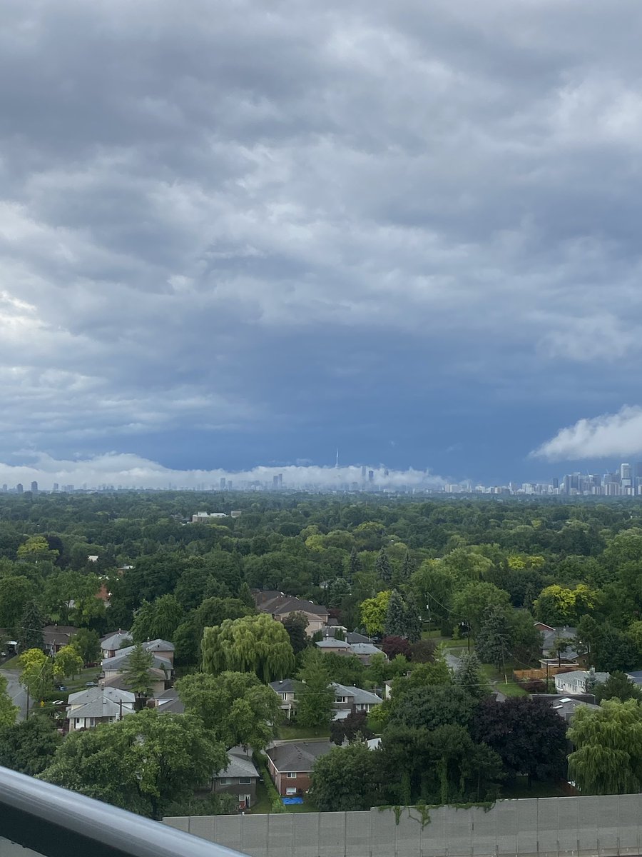 feebeecee's tweet photo. Summer storms are crazy. But this is kinda cool…? 

A long and low horizontal cloud hovering over downtown Toronto. CN Tower is trying to peep through. 👀

#ONStorm https://t.co/gZBH4GKj4H