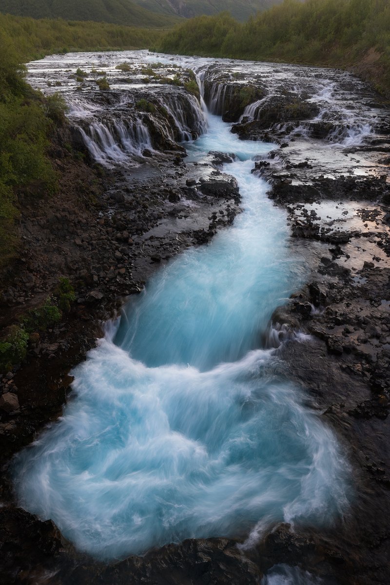 Bruarfoss, meaning Bridge Falls. Although this view was taken from a bridge over the river, the name refers to a natural stone bridge that was once there.
.
This location was such a powerful place with water that's bluer than any that I have seen
.
#iceland #bruarfoss #Rivers