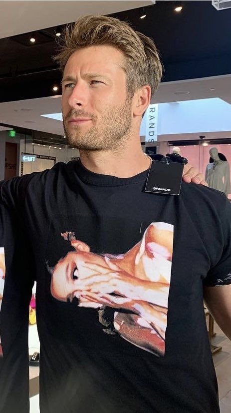 notgwendalupe's tweet photo. Glen Powell with Ariana Grande merch https://t.co/xcvX0hLLIj