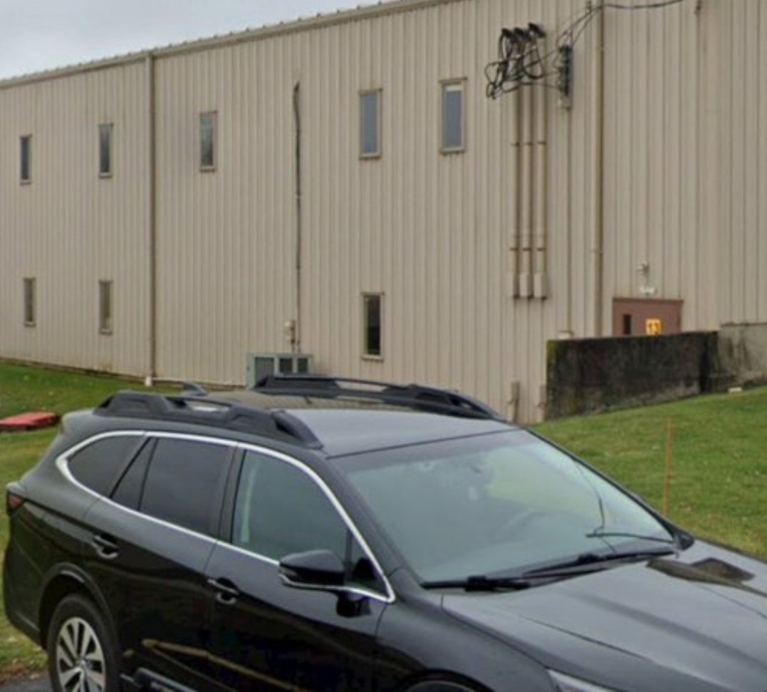 NMP562's tweet image. Im hearing this is not a drone pic, but a screen grab from cctv footage from a camera that was above the backdoor of building. 

It was taken while he was sitting on this barrier wall.