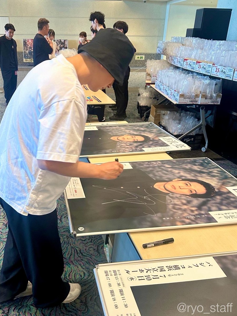 こちらは当日、会場についてすぐポスターにサインする吉沢✍️奥に