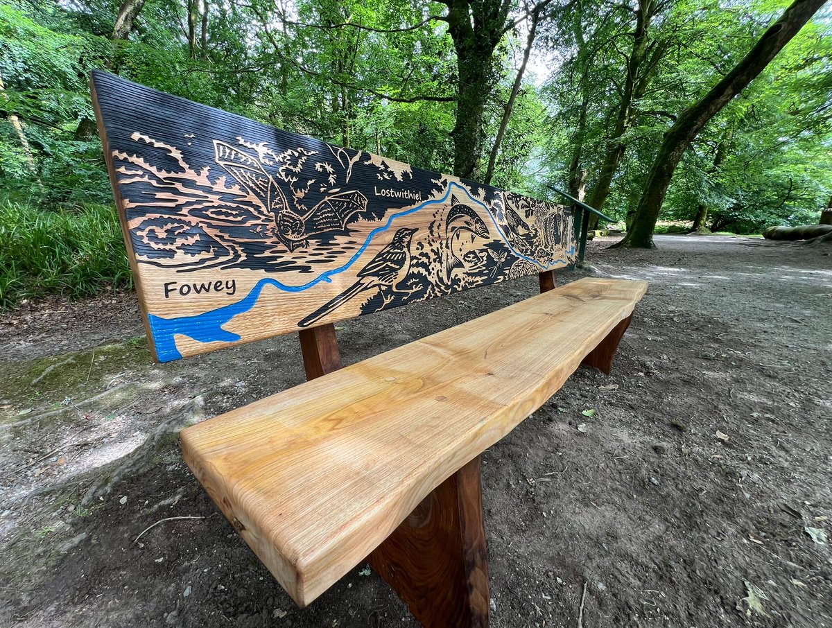 GreenspacePegs's tweet photo. A new etched bench at the magical Golitha Falls @Cornwall_NL replaces our original which was retired after more than 20 years' service. The #fowey is picked out in blue and surrounded by local flora and fauna, inspired Mike Langman @clennonvalley artwork @NE_DCIoS #Benches https://t.co/wVJHTIEt8V
