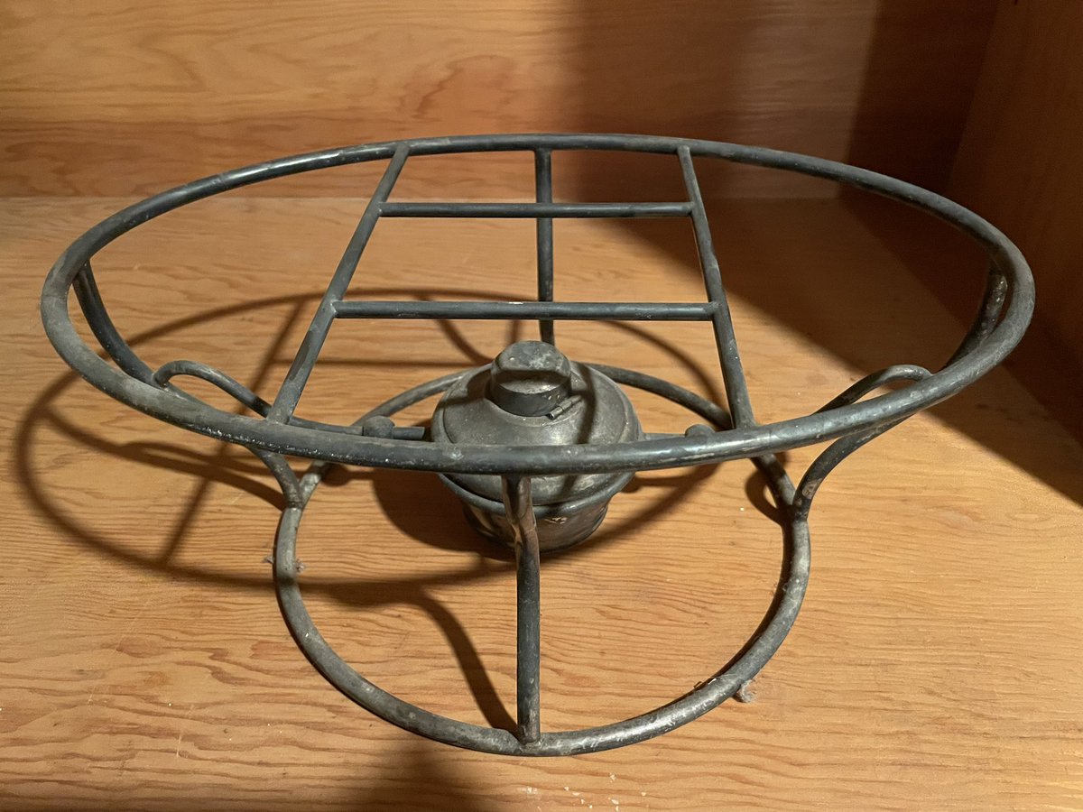 Does anyone know what this is? I found it in the basement of my 100-year-old house. The little round thing pops out and looks like an alcohol burner with a cloth wick inside.

Ideas on what I could use it for? Plant stand?