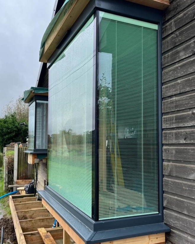 These frameless windows on the Norfolk Broads give a virtually seamless outlook! 
We also installed in-glazed Venetian blinds for these customers - perfect to control light &amp; shade, and also to give privacy - especially at night when the lights are on &amp; boats are sailing past!
