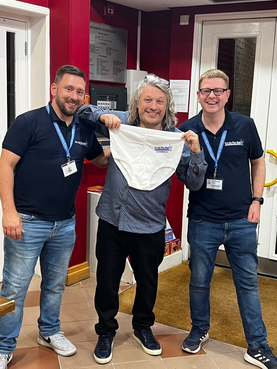 Itsontheball's tweet photo. Two of our trustees had the pleasure of meeting @Herring1967 at his ‘can I have my ball back’ show last night. Thanks to @norwichplay for allowing us to have our awareness stand, and especially to Richard for being a good sport and posing for our ‘pants wall of fame’. https://t.co/LJL79uHouL