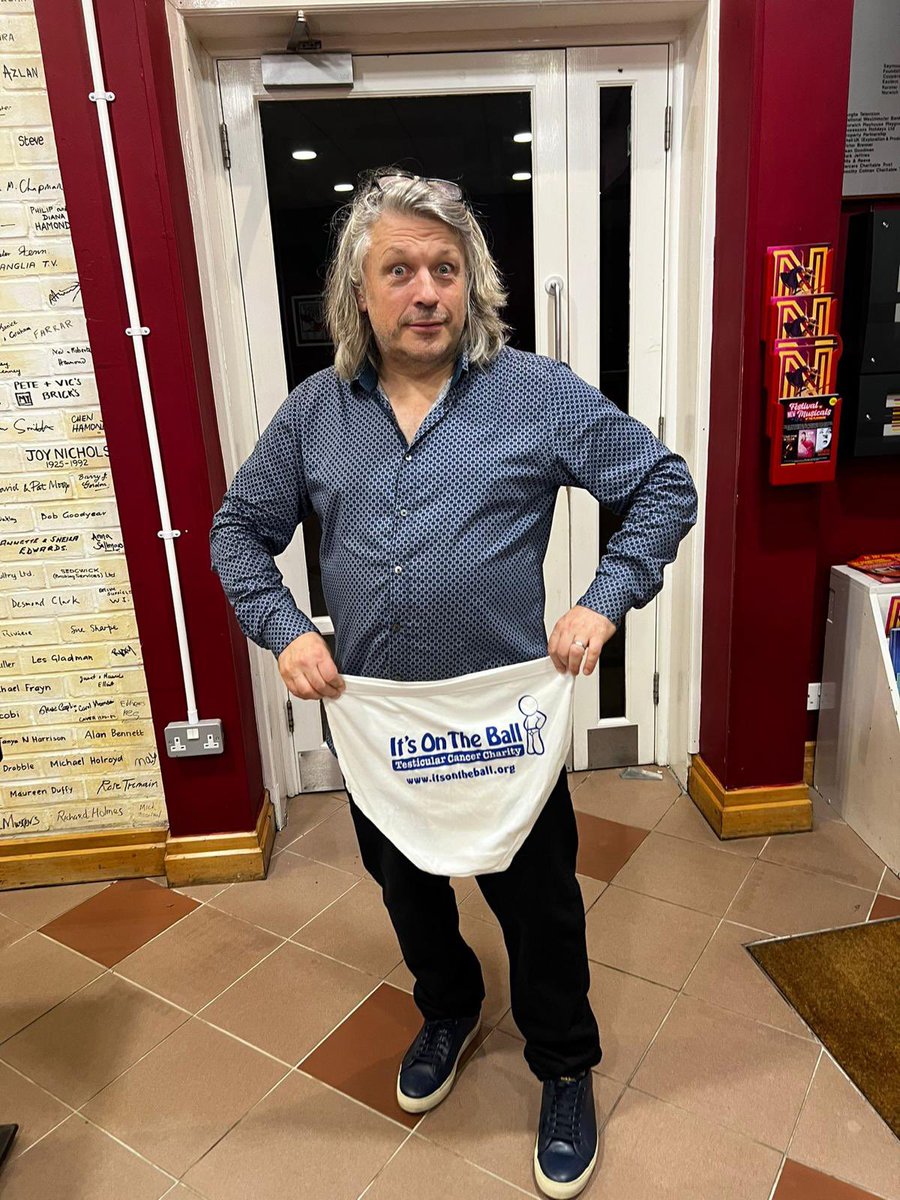 Itsontheball's tweet photo. Two of our trustees had the pleasure of meeting @Herring1967 at his ‘can I have my ball back’ show last night. Thanks to @norwichplay for allowing us to have our awareness stand, and especially to Richard for being a good sport and posing for our ‘pants wall of fame’. https://t.co/LJL79uHouL