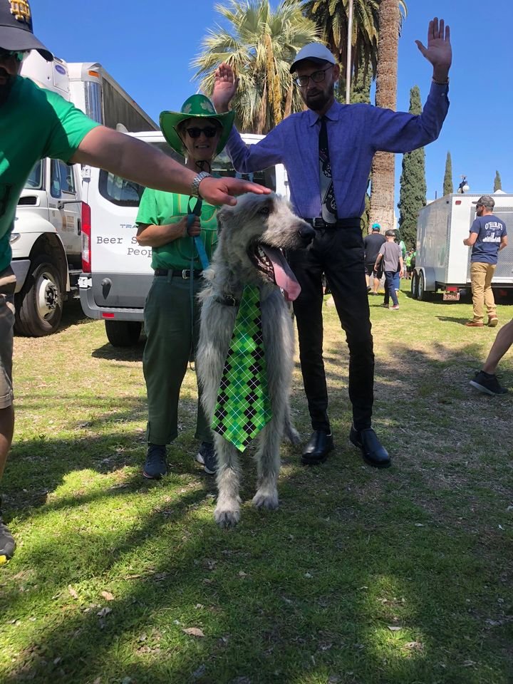 WisdomComedian's tweet photo. Mr Leight in blue long sleeve shirt, tie, black shoes with beard and white hat, arms raised to head level, standing with large dog .... https://t.co/sFeRTwDRIr