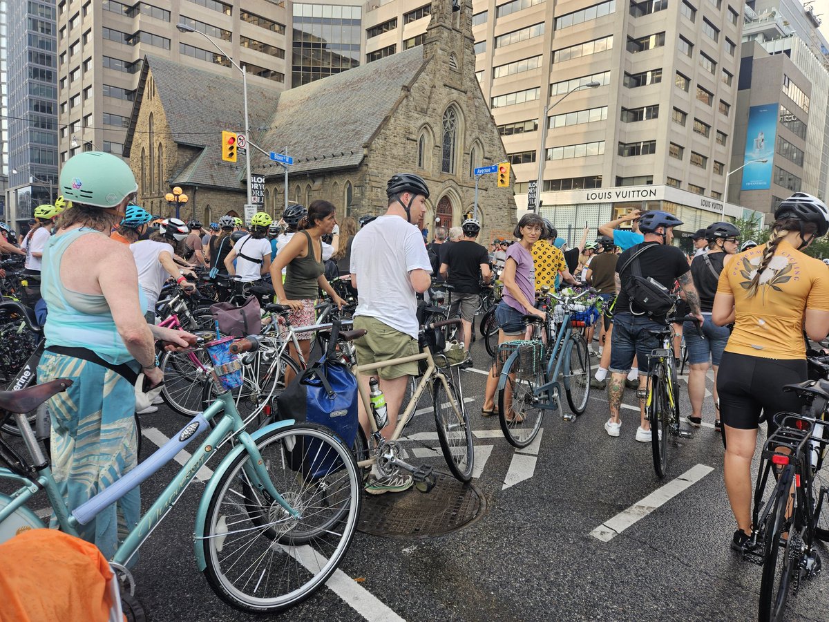 JessicaBellTO's tweet photo. Here we are at the intersection of Bloor St and Avenue Rd. I have never seen this many people at a memorial ride for a killed cyclist.  We are mourning.  We are angry.  We demand safe streets. https://t.co/NNvtfPqkde