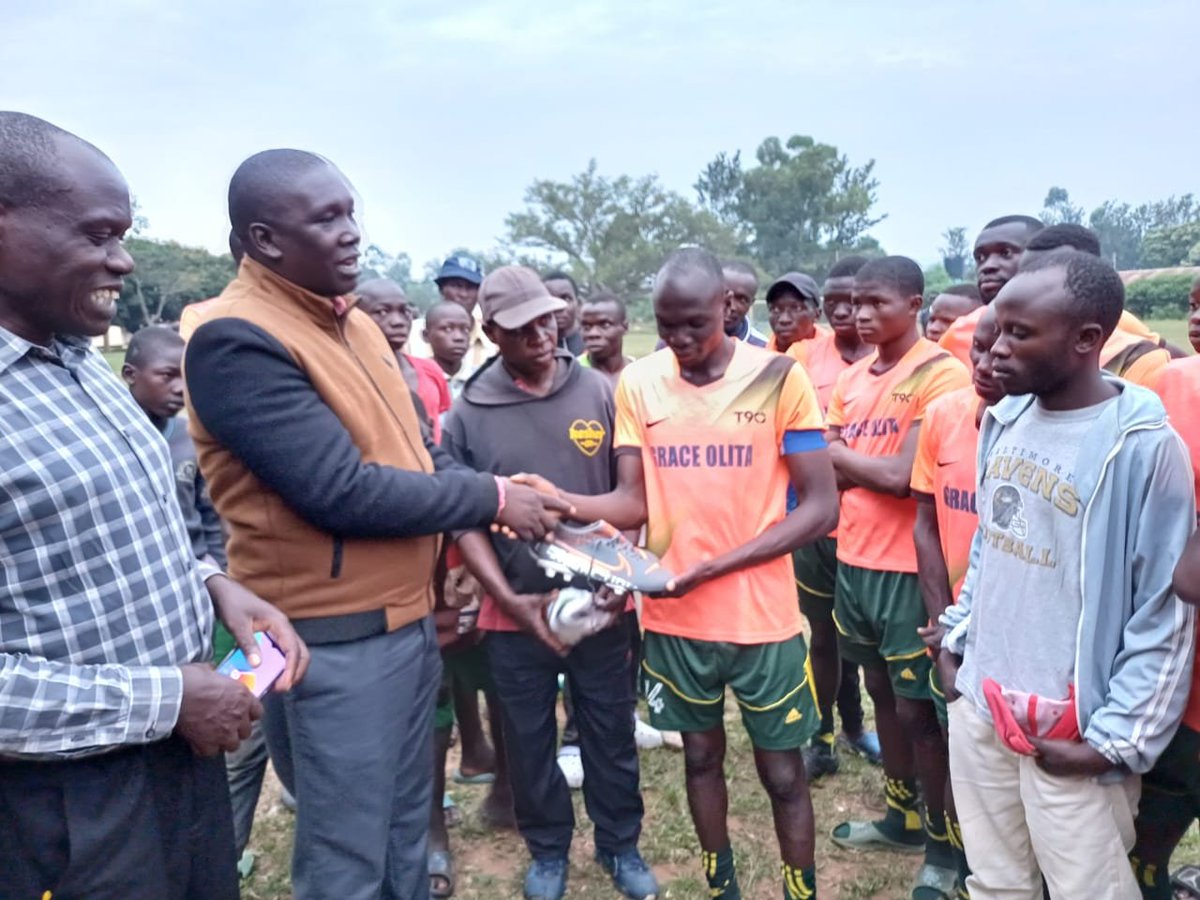 Our supporter Mr. Cyrus Ipapo donated a pair of football boots to our Captain as Vice Chairperson watches.
