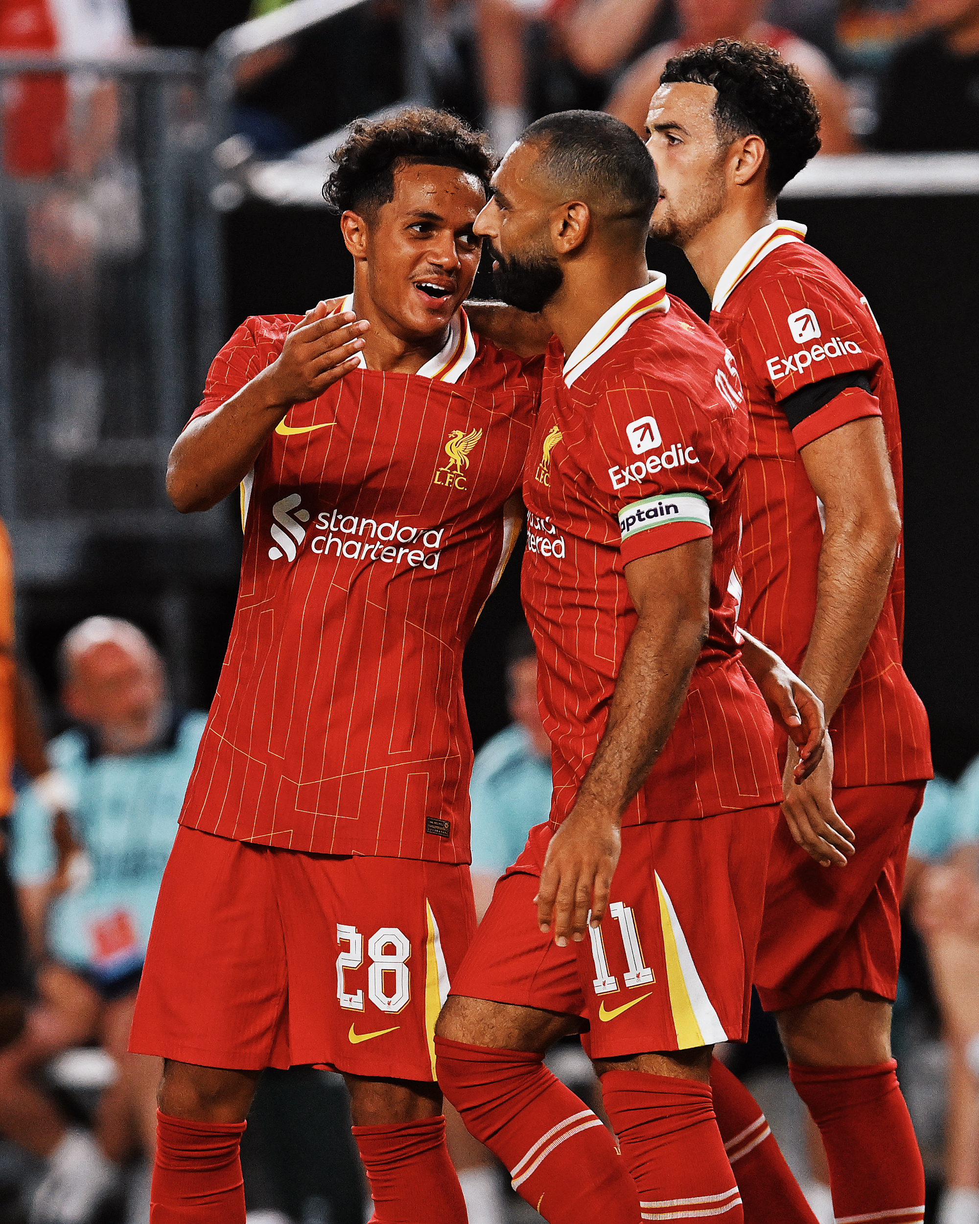 Photography of Fabio Carvalho and Mo Salah celebrating during Liverpool FC vs Arsenal.