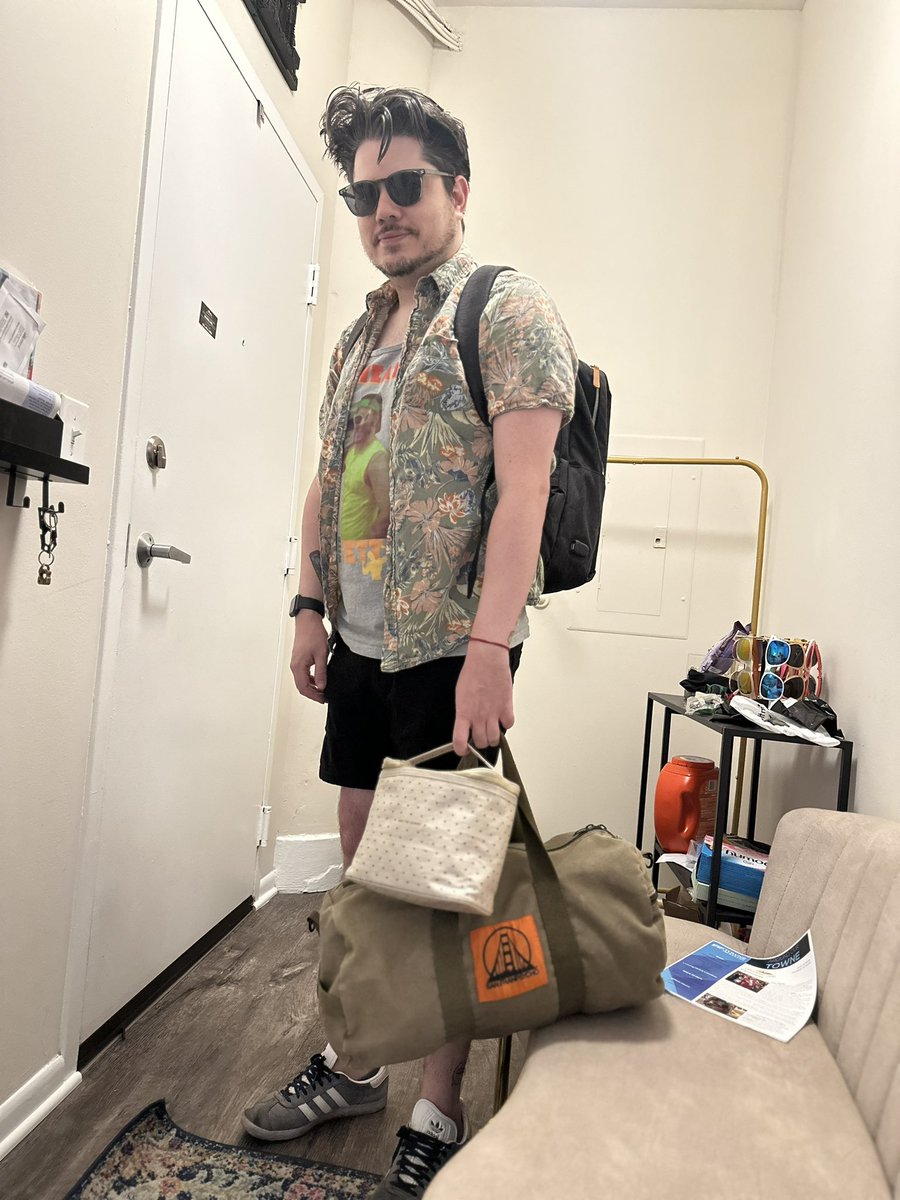 My sister insisted on taking this pic of me before I left for GenCon (shout out to <a href="/CastPartyDND/">CAST PARTY</a> — wearing my “Sweat with Jett” tank)