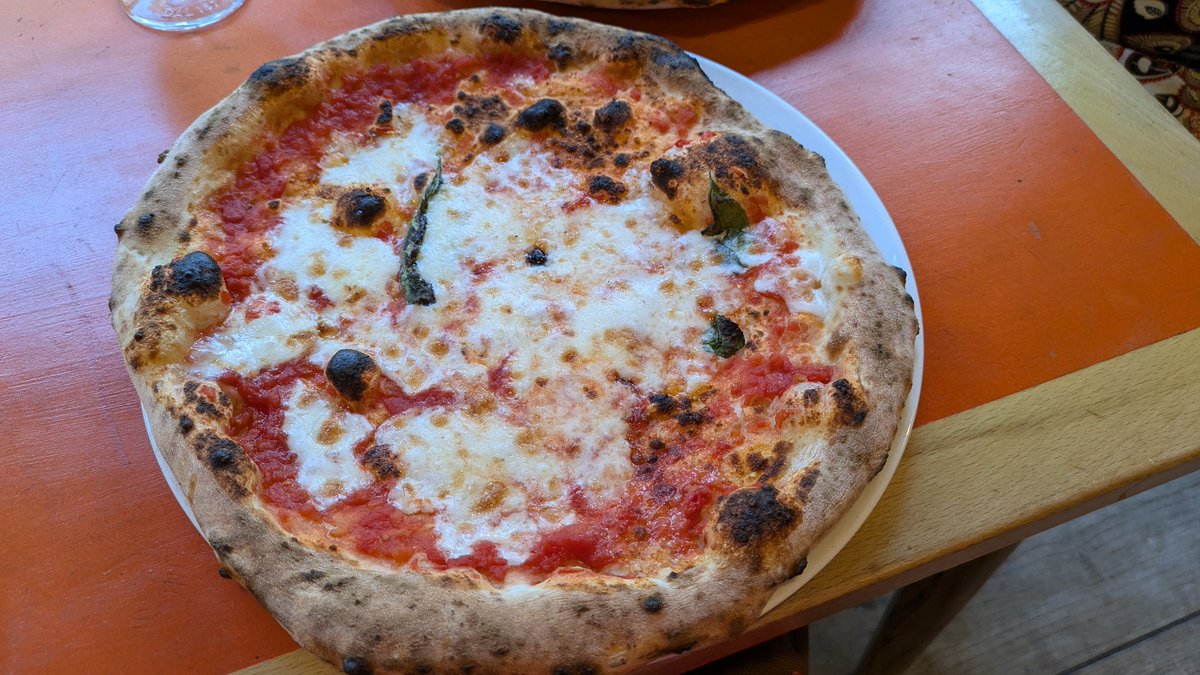 I can confirm that the Napolitan pizza at Rudy's on Division St Sheffield is indeed as close as I think you'll get in the city, Paesani excepted, great dough, San Marz tomatoes and, always screwed up in this country, fiore di latte NOT mozzarella