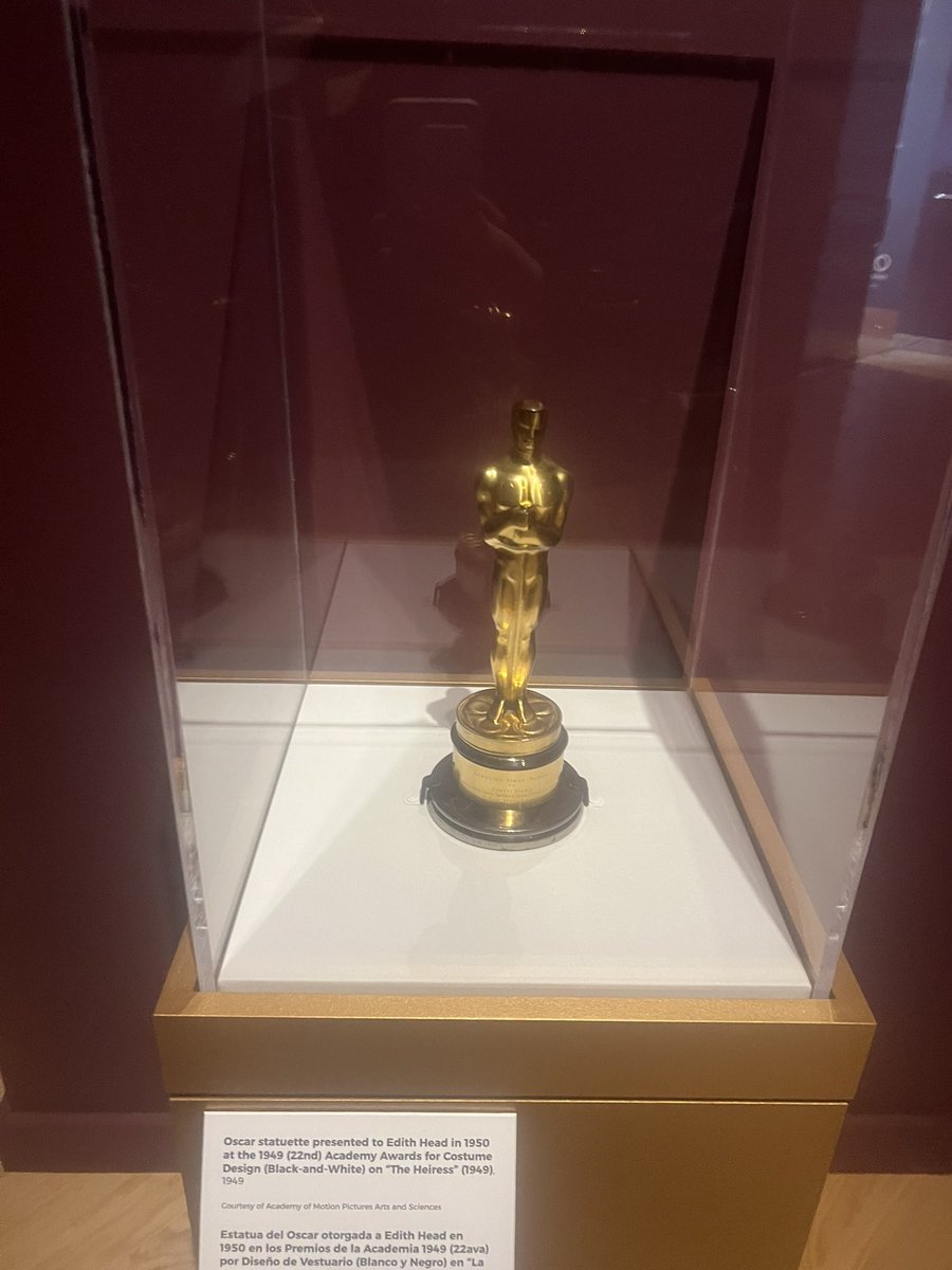 classicblondess's tweet image. My tour of the Edith Head exhibit at @OKCMOA 🧵 When you walk in, the first thing you see is this Olivia DeHavilland dress from The Heiress. Head called this film “possibly the most perfect picture I have ever done.” Her Oscar for the film is right next to it.
