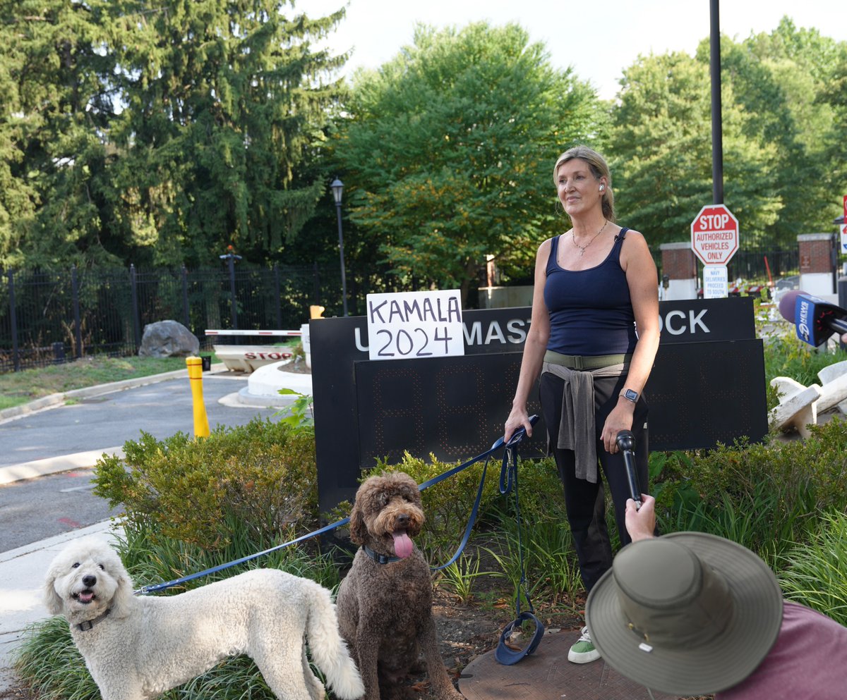 PenguinSix's tweet photo. A Kamala Harris supporter puts up a sign at the US Naval Observatory in support of the @VP