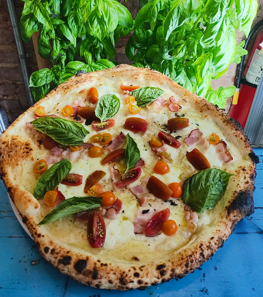 We're bringing this pie back as our weekly special! 😍Topped with buffalo mozzarella, sliced provolone, pancetta, Pecorino Romano, EVOO, fresh mixed grape tomatoes, and basil from our in-house hydroponic garden, you can enjoy it at our Midtown location starting this Wed. 7/24.