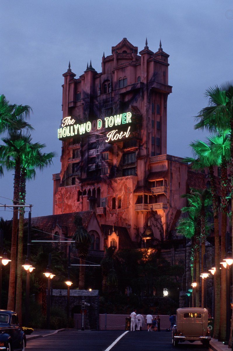 JLHomni's tweet photo. Taken just a month before opening in 1994 this duo of publicity shots of the Hollywood Tower Hotel shows its original "Character Finishes"* complete with prominent electrical scorch marks, still-wrapped palms, and sedate/realistic lighting scheme.
#HTH30
*Paint & Aging https://t.co/yyxNvQl1i7