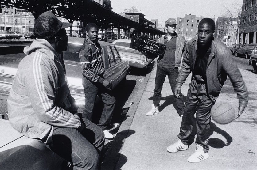Boston, 1986.

Men sit outside of Northampton Station on the Orange Line near Lower Roxbury/ the South End. Notice the Adidas shoes and jacket. 

Northampton Station was decommissioned in 1987 when the Orange Line was rerouted. 

📷: Linda Swartz