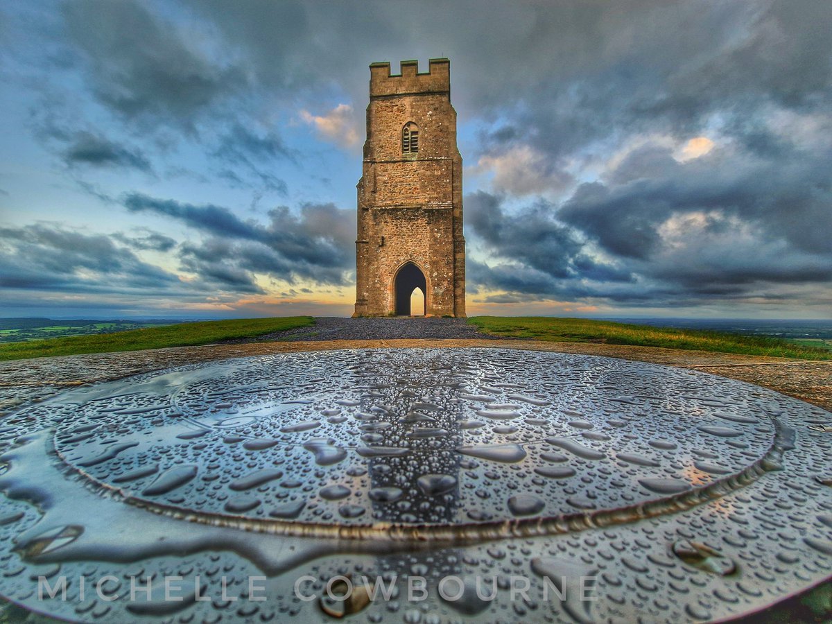 Glastomichelle's tweet image. Reflections and rain on the compass stone. Taken at sunrise on Glastonbury Tor.