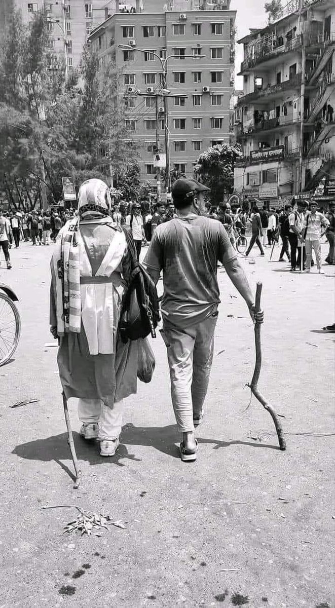 A brave father with his daughter came to the street in Dhaka to fight against state terrorism. Salute to those parents who have shown courage to fight against Indian puppet dictator Sheikh Hasina. Bangladesh will be independent again. #StepDownHasina 
#BanAwamiLeague