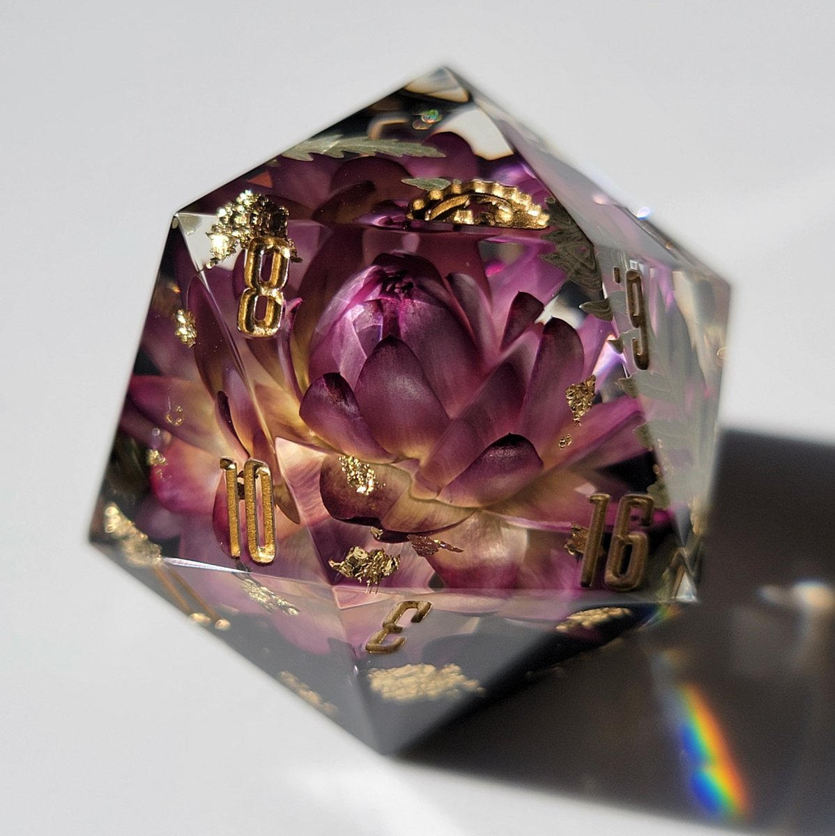 dicedumpling's tweet photo. 🌿🌸[ 𝔼𝕞𝕖𝕣𝕘𝕖𝕟𝕔𝕖 ]🌸🌿 the flower in this D20 looks like it's barely starting to bloom &amp; unfurl in the morning light 💖 also purple dice look regal af 👑✨️ https://t.co/fTUXQmKqgi