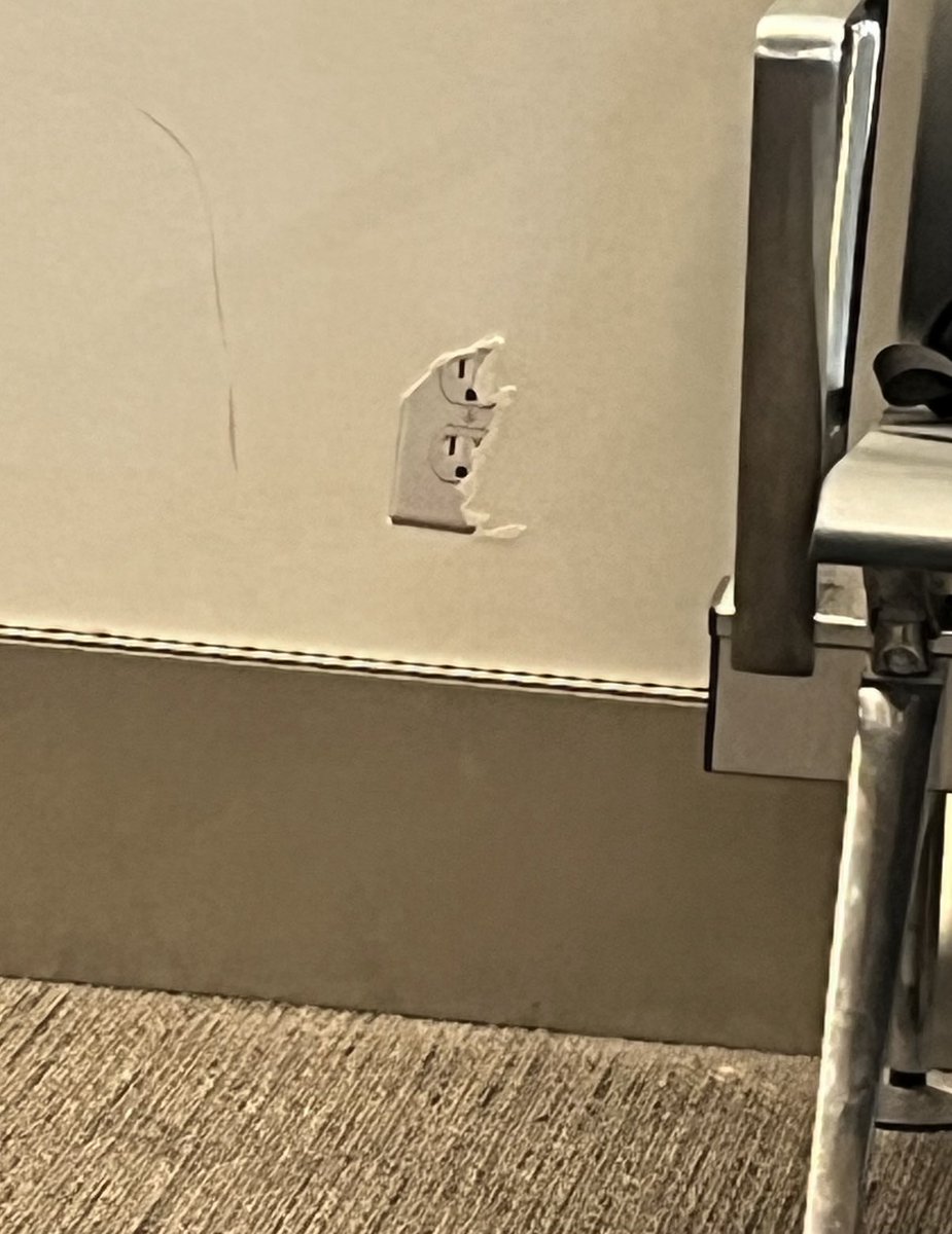 CHR1SCHR1S's tweet photo. Electrical plug sticker? Cruel airport prank https://t.co/W0hmQXgarA