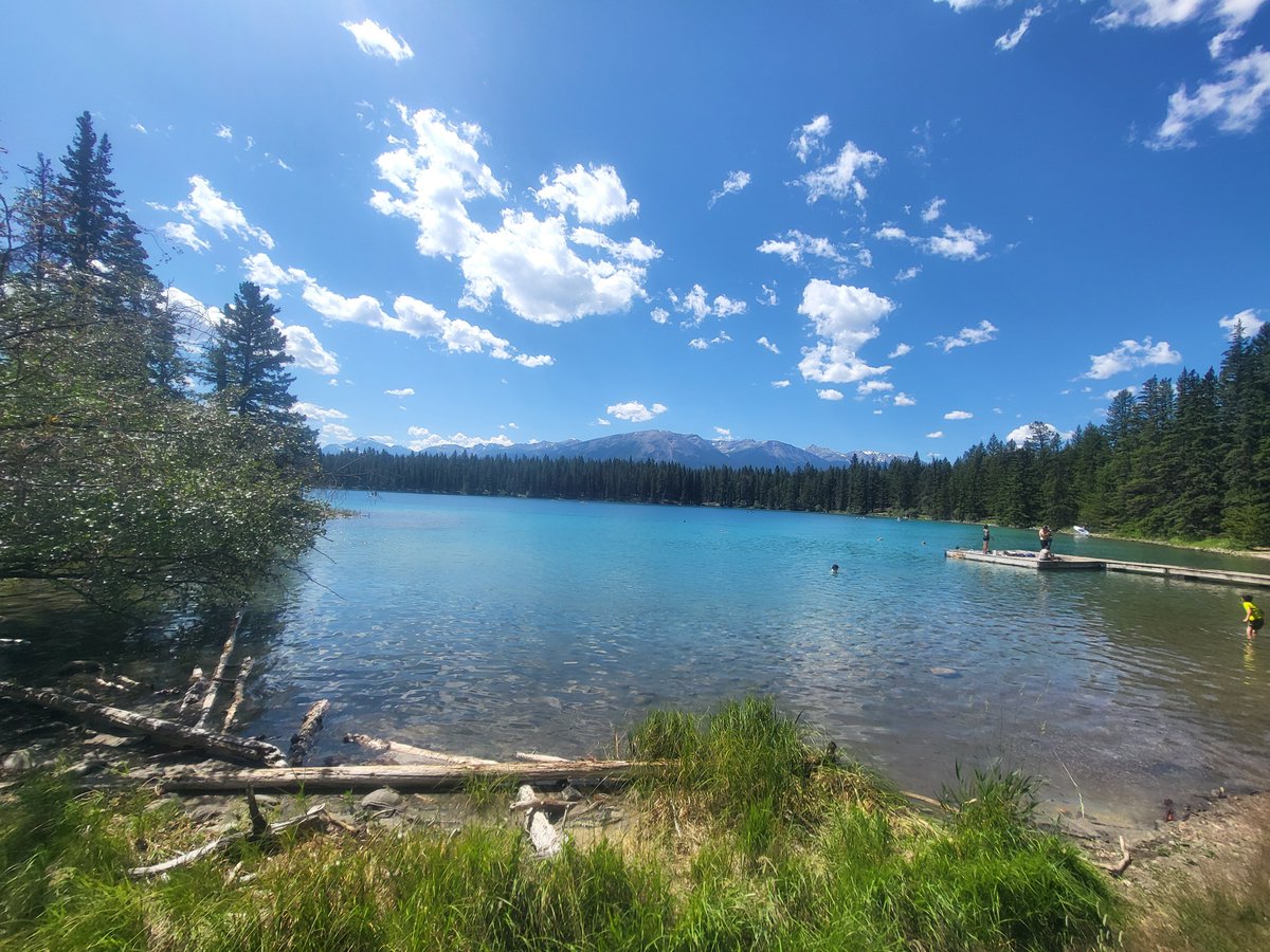 SarahRyanYEG's tweet photo. I took these photos just 8 days ago. Never did I think #Jasper would be burning a week later. This is Lake Annette, near JPL. It's my favourite lake in the entire country. Warm, crystal clear water, views for days, a soft sandy bottom, loon calls and elk sightings #ABWildfire https://t.co/JxnZQ3uudm