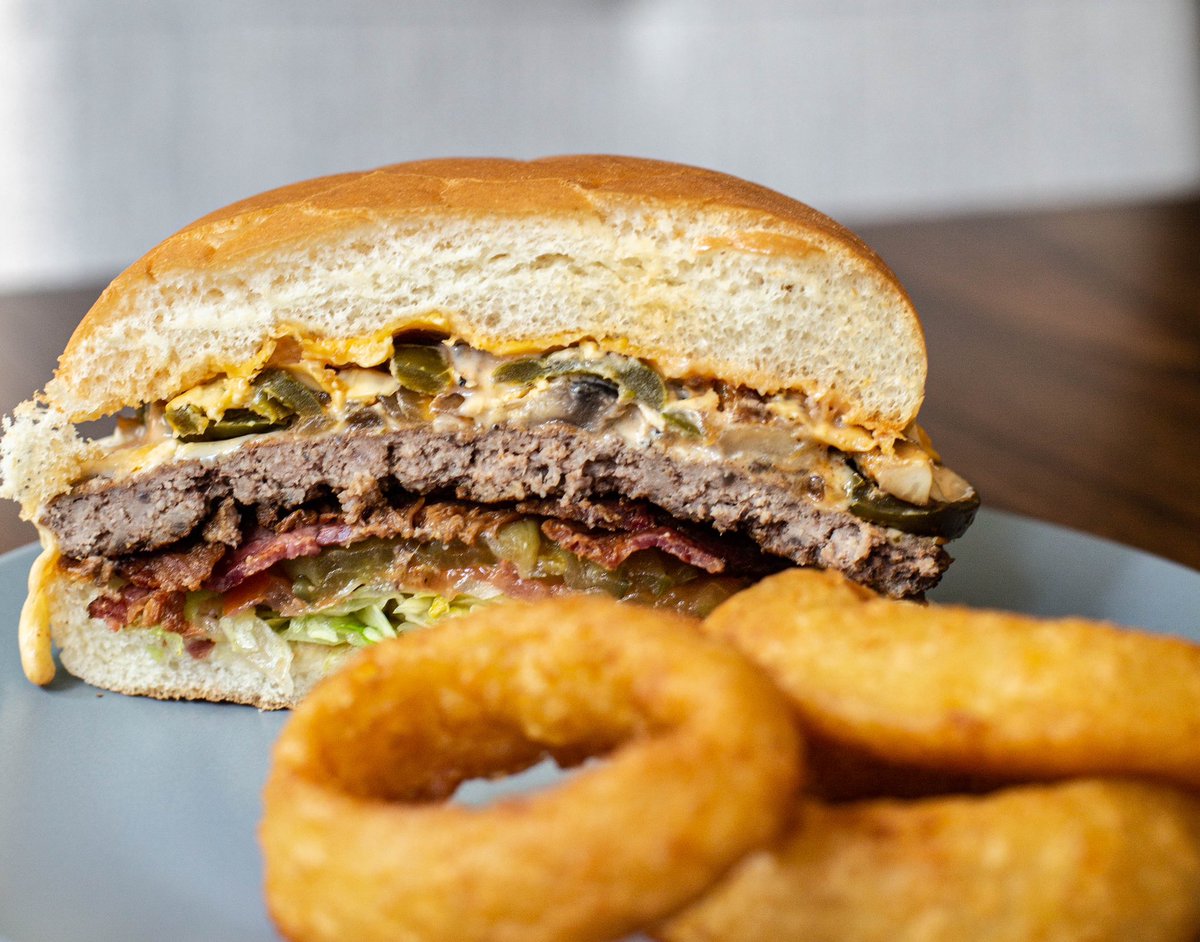 🍔 Satisfy your cravings with our mouthwatering burger, packed with bold flavors and paired with the crispiest onion rings! 😋 Come and taste the deliciousness at Olive Burger Company. #burgerlove #oliveburger #eatoliveburger #burger #halalburger #burgerporn #dallasfoodies