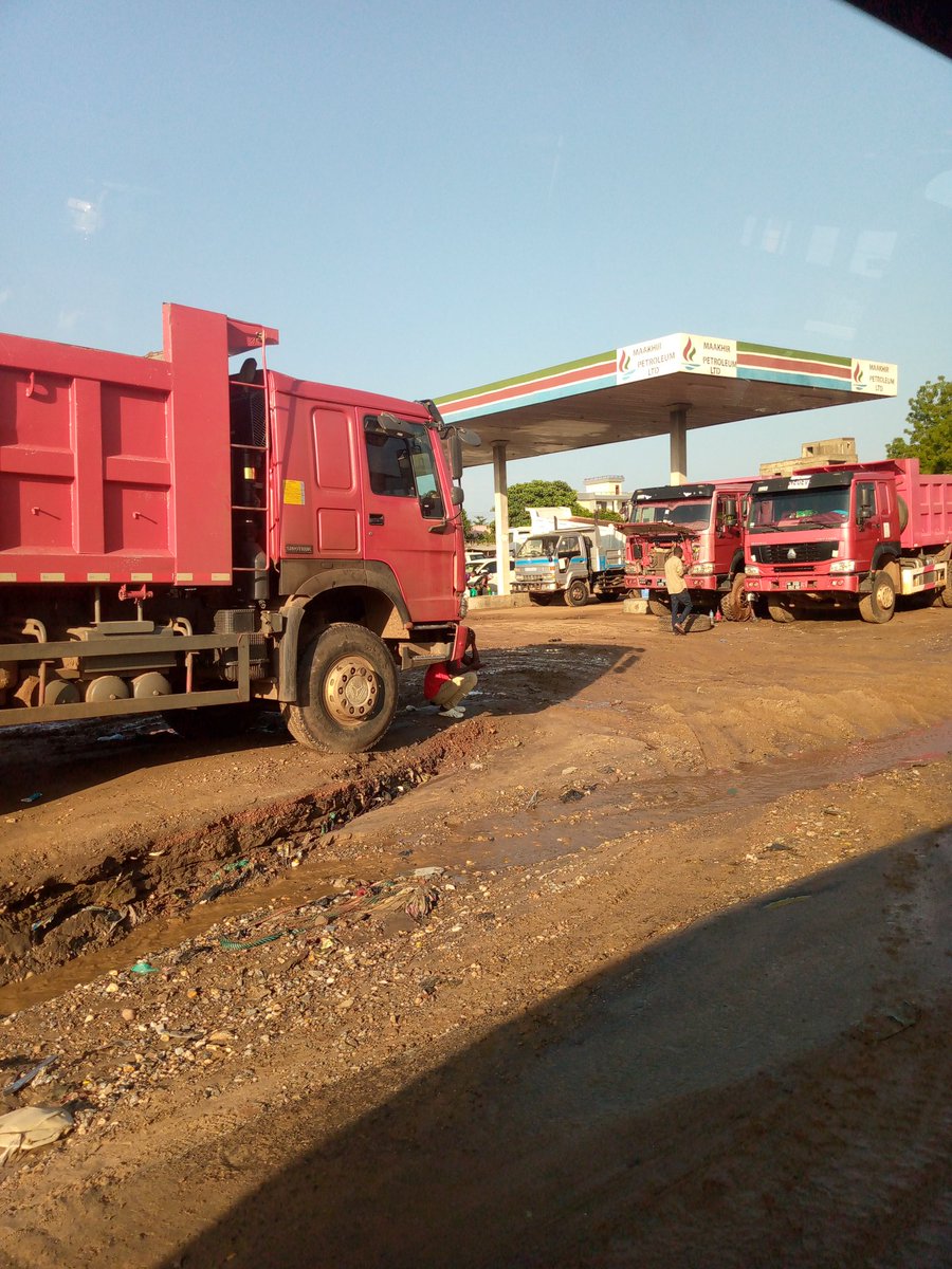 RoadsSSD's tweet photo. #SSOX. This petrol station in Gudele 1 is joking. They have been there for more than 10 years but what we get in return is damaging our tarmac with their heavy trucks. They need to be visited by the Mayor of Juba and have their license withdrawn. The place is full of mud. https://t.co/HId0WjVbdZ