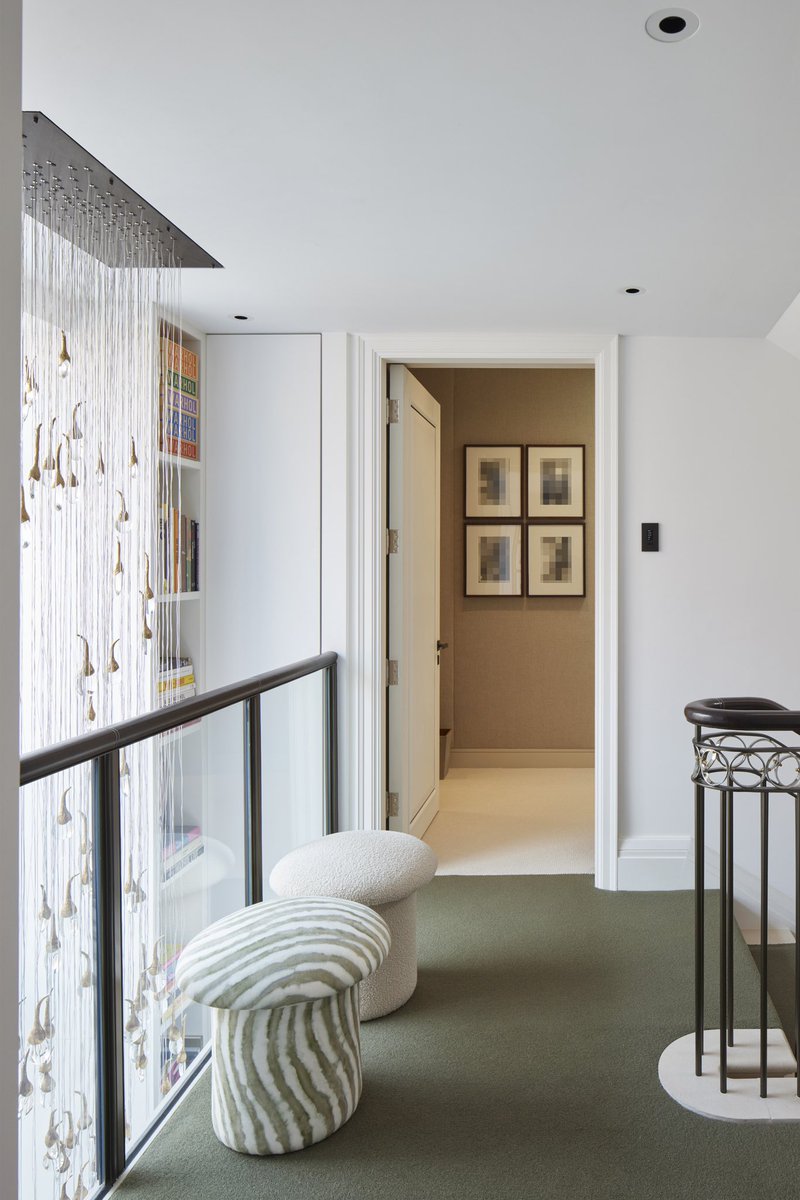 This large frosted-glass window connects the ground and first floors, allowing light to flood the stair landings on both levels. Framed by bookshelves and comfy seating, it creates a cosy reading nook.

#shhlondon #architecture #familyhome #residential #architects