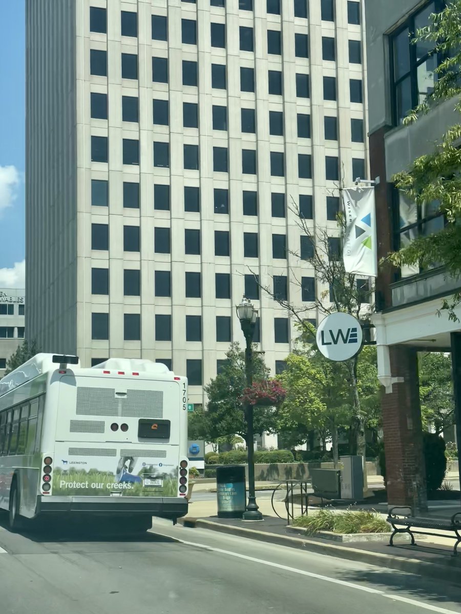WiserStrategies's tweet photo. Now that's great timing! The Wiser Strategies banner proudly hangs on the side of our building as our ad can be seen on the back of a Lextran bus. We love creating collateral for LFUCG and placing it for all in Lexington to see. #ProtectOurCreeks and #WiserWays forever. https://t.co/0Vt9W7l2mn