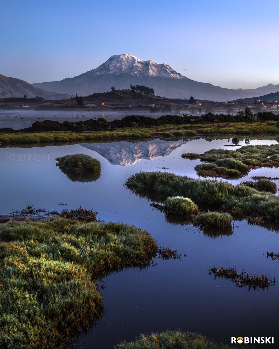 Volcán Chimborazo reflejado en la Laguna de Colta durante un despejado amanecer.