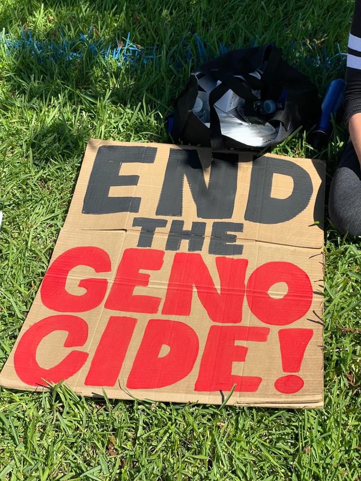 sdesfl's tweet photo. Alt text: 
Photo 1: “this is a genocide on the entire demography of Gaza” - Bisan Owda
Photo 2: end the genocide on cardboard 
Photo 3: cardboard that reads shut down real time labs stuck behind the back windshield wiper of a Boca PD police SUV
Photo 4: two ignore a yelling Zio https://t.co/3WVb6SuPbf