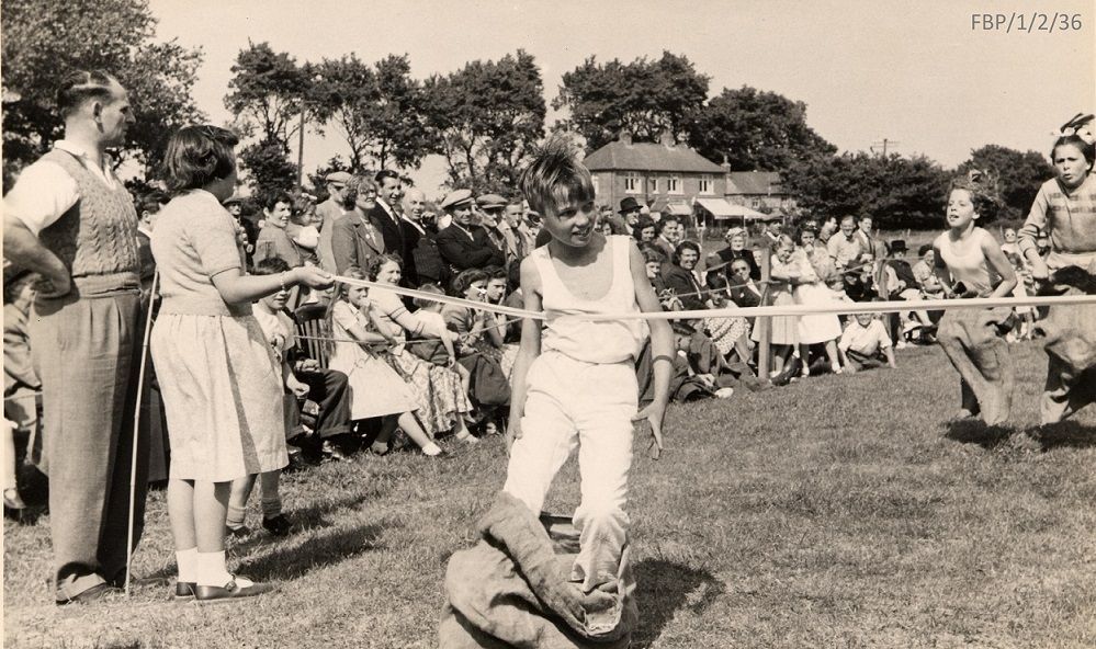 School sports days can really feel like the Olympics when you are a child! 🥇 This is a photograph of a sack race at Fishbourne School in the1950s, and just look at the determination on their faces! #Olympics2024 #ParisOlympics