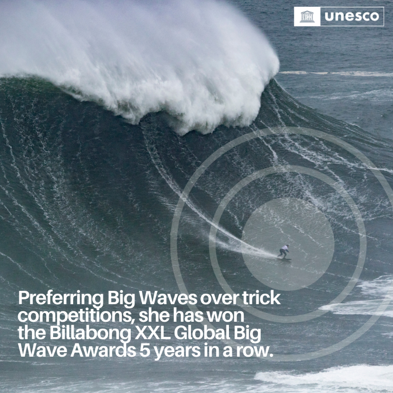 UNESCO's tweet photo. @UNESCO's Champion for the Ocean and Youth, @MayaGabeira, has not only conquered enormous waves but also set numerous world records, inspiring a new generation of surfers.

Maya continues to #ChangeTheGame! 🏄‍♀️