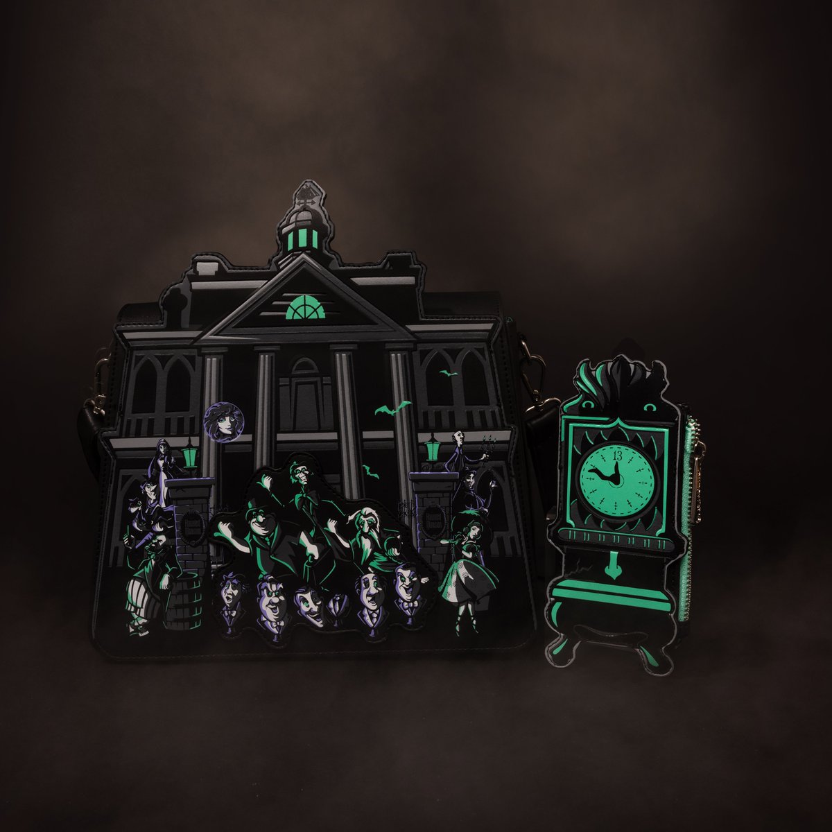 Loungefly's tweet photo. All our favorite happy haunts on one bag 👻 This glow-in-the-dark Haunted Mansion collection is available only from Amazon at https://t.co/B7dN1H5eCk https://t.co/fgiVDoQ3Ob