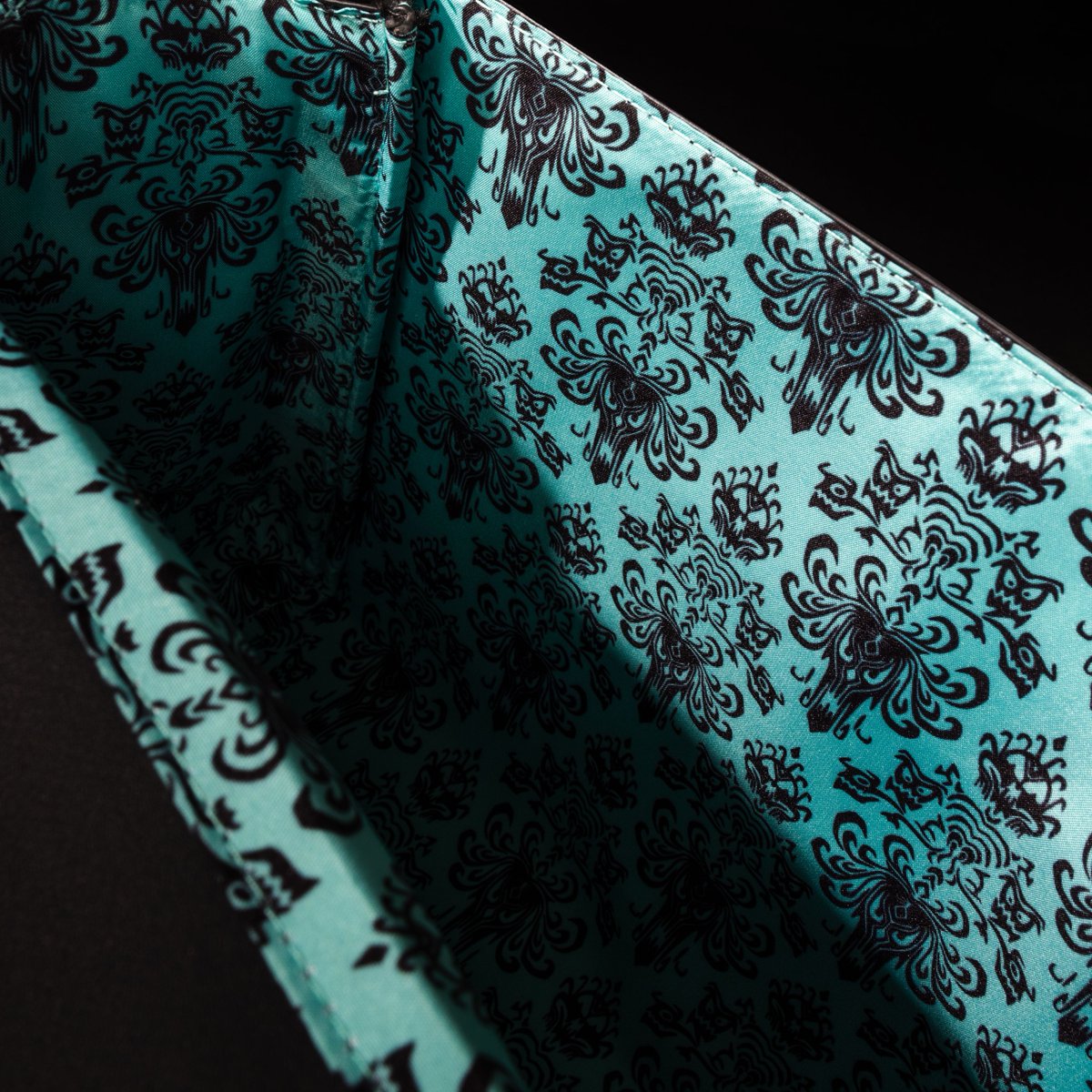 Loungefly's tweet photo. All our favorite happy haunts on one bag 👻 This glow-in-the-dark Haunted Mansion collection is available only from Amazon at https://t.co/B7dN1H5eCk https://t.co/fgiVDoQ3Ob