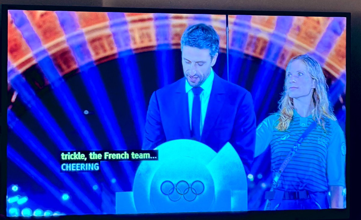 DocsDoItBetter's tweet photo. The first gold medal goes to this poor woman - her arm must be killing her! #OpeningCeremony #Paris2024 https://t.co/KZLXdiX2Wo